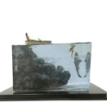 sculpture of a person rowing a boat and another person swimming with a shark coming to eat them