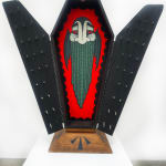 Open coffin with black doors and painted vampire on red background on inside