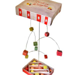 ceramic mobile of a box of candy exploding open