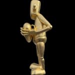 ;eft side view of a gold robot statue holding a heart