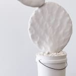 Brock DeBoer sculpture of white porcelain cactus clipping in white bucket with white gravel
