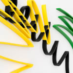 Close up of Multi color scribble artwork from Arnaud Vidricaire made of laser cut wood in yellow black green and blue