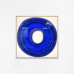 Ted Collier Circle Series painting with blue circle coated in resin on a white canvas hanging on a white wall