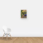 Wall view of painting of a large cat peering into a living space through a door