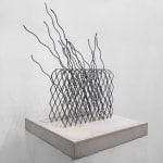 Detail of wire sculpture on cement base