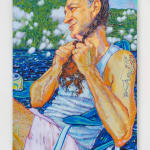 Man with long braid and nurse tattoo sitting dockside