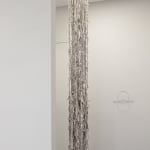 Newspaper tendrils suspended from the ceiling