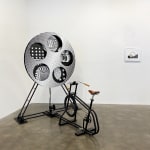 An interactive sculpture that uses a person on a bike to rotate a psychedelic-patterned disk