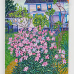 White house with pink flowered bush in foreground