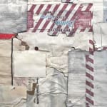 Close-up of cardboard assemblage that resembles an abstract quilt with stripes and irregular pieces