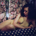 Photograph of nude Kusama with her signature polka dots in background