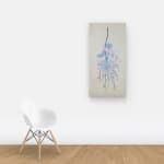 Multicolored collaged branch and leaves hung on wall