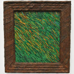 A grassy field surrounded by a heavy frame made from strips of colored tin