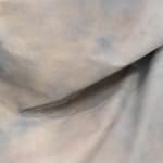 detail shot of draped fabric sculpture on wall
