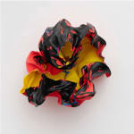 Fabric multi colored flower sculpture on wall