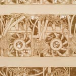 a detail of a lasercut paper artwork on a white wall