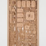a laser sculpted wood sculpture on a white wall