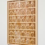 a laser sculpted wood sculpture on a white wall