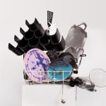 Sculpture with various china, ceramic, kitchen utensils and modified dishwasher on pedestal