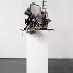 Sculpture with various china, ceramic, kitchen utensils and modified dishwasher on pedestal