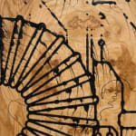 a detail of a large wooden sculpture on a white wall