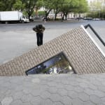 corner of building coming out of sidewalk