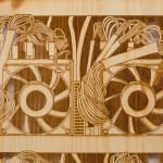 a detail of a laser sculpted wood sculpture on a white wall