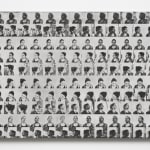 a grid of faces in black and white on a panel
