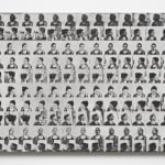 a grid of faces in black and white on a panel