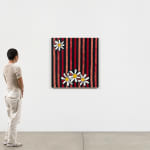 Scale of figure standing near striped needlepoint painting with daisys against white wall