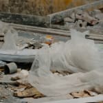Karyn Olivier's Drift (Tributary), a video still of recyclables and debris on a conveyer belt