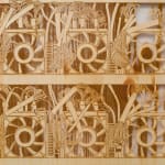 a detail of a laser sculpted wood sculpture on a white wall