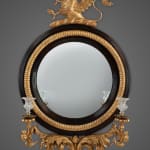 Regency carved giltwood and ebony convex mirror with griffin crest
