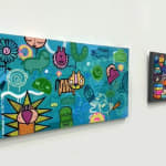 Two cartoon street style art landscape painting hung on gallery wall