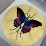Purple, black & blue electric butterfly on gold leaf background circular background