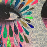 Woman's face with multi coloured shapes around eye