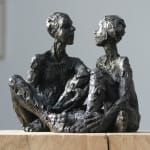 Seated Male & Female iron resin sculptures