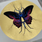 Purple, black & blue electric butterfly on gold leaf background circular background