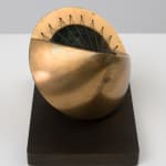 small bronze sculpture with a green inside