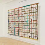 a large gridded painting hanging off the wall