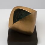small bronze sculpture with a green inside