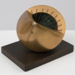 small bronze sculpture with a green inside