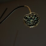 A close up of a bronze lotus pod