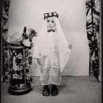 1960s black & white photograph of a young child wearing ethnic Middle-Eastern garb in a photography studio