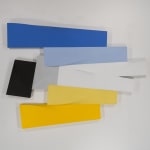 Tridimensional, bas relief horizontal painting made of interconnected trapezoid shapes (yellow, gray, blues, black)