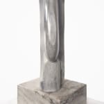 Side view of a modernist marble sculpture of an abstracted woman's face in profile on a marble base