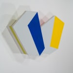 Detail of Tridimensional painting of two interconnected white rectangular prisms with colored sides (blue, yellow)