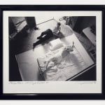Framed Black and white photograph of photographer Douglas Kirkland doing a photoshoot of Marilyn Monroe in bed, taken from a high vantage point