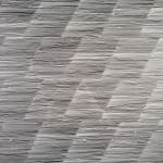 Graphite on paper drawing of longer and shorter lines creating a diagonal pattern.