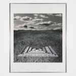 Framed black and white photomontage of an abstract structure in a baren landscape